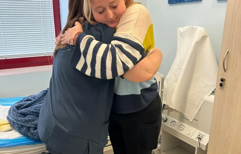 CRPS-Support Patient and caretaker hugging eachother in Italy after neridronate infusions