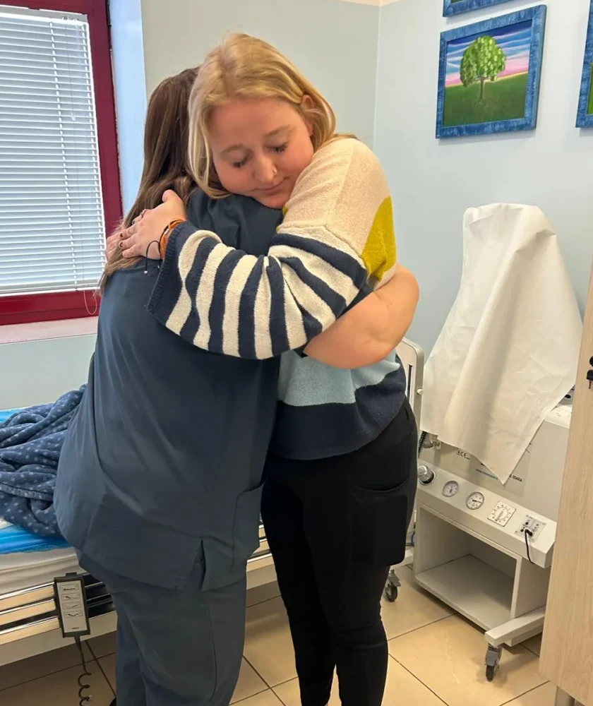 CRPS-Support Patient and caretaker hugging eachother in Italy after neridronate infusions