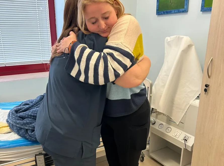 CRPS-Support Patient and caretaker hugging eachother in Italy after neridronate infusions