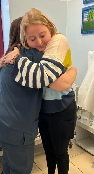CRPS-Support Patient and caretaker hugging eachother in Italy after neridronate infusions